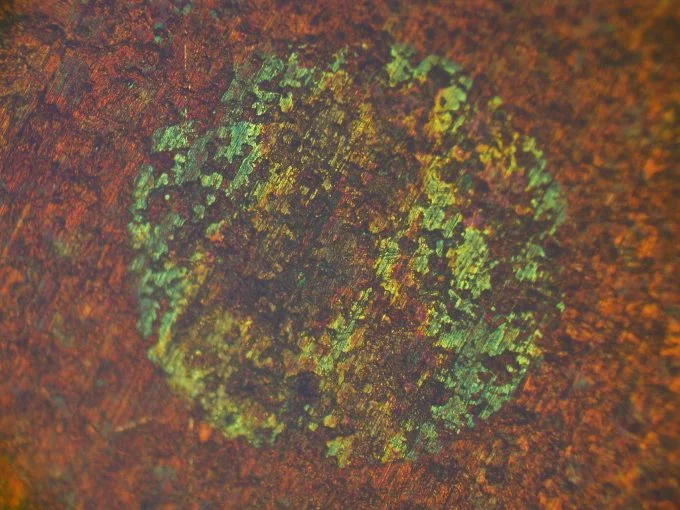 Pinhole corrosion in copper tubing revealed by Nomarski phase interference contrast microscopy.