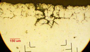 Cross Section Testing Services - Cross section of a Ni-based alloy material of a reactor flange that exhibited various forms of cracking and corrosion in a high-temperature chemical processing environment.