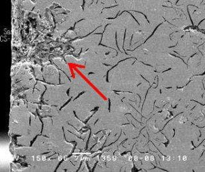 Metallographic analysis: A damaged area is plainly visible penetrating the pipe wall from the outer surface at the left. This form of attack, known as graphitic corrosion, is specific to grey cast iron.