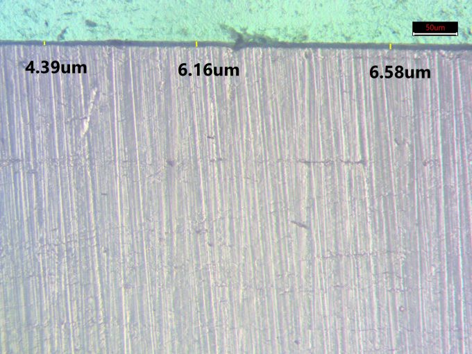 Optical photomicrograph of cross section of polycarbonate with abrasion resistant coating with thickness measurement of coating, Product 1